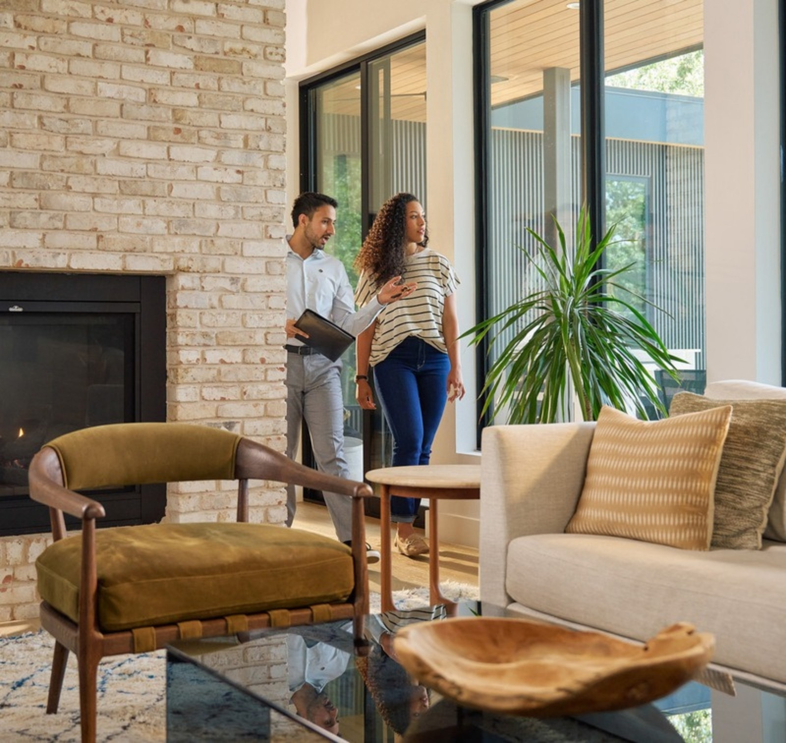 CENTURY 21 Together agent guiding a client through a bright living room