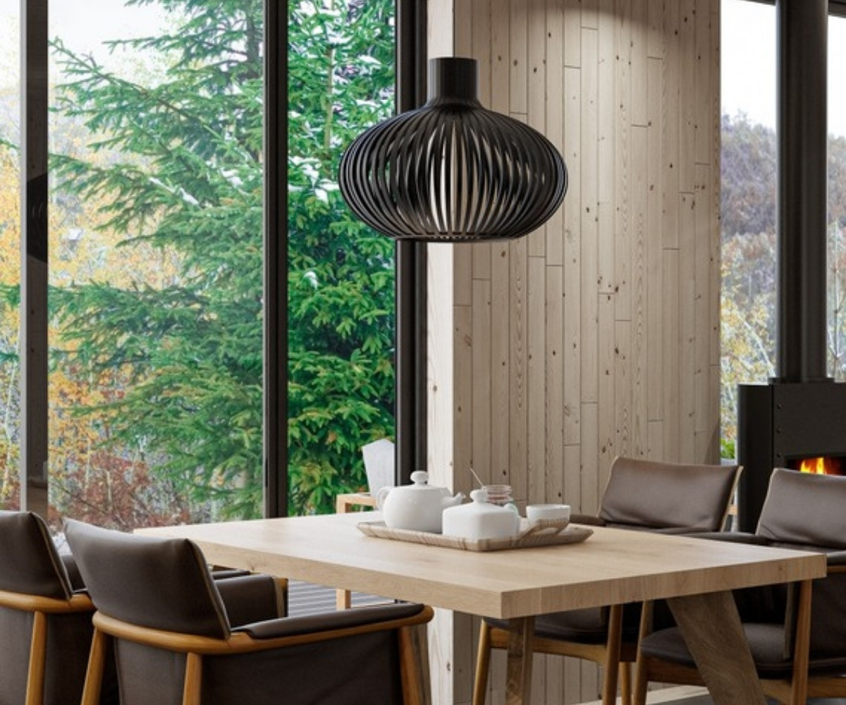 Warm, staged dining room with natural wood and soft pendant light