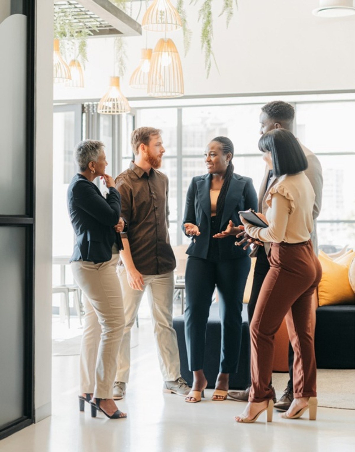 Real estate team talking together in a bright office