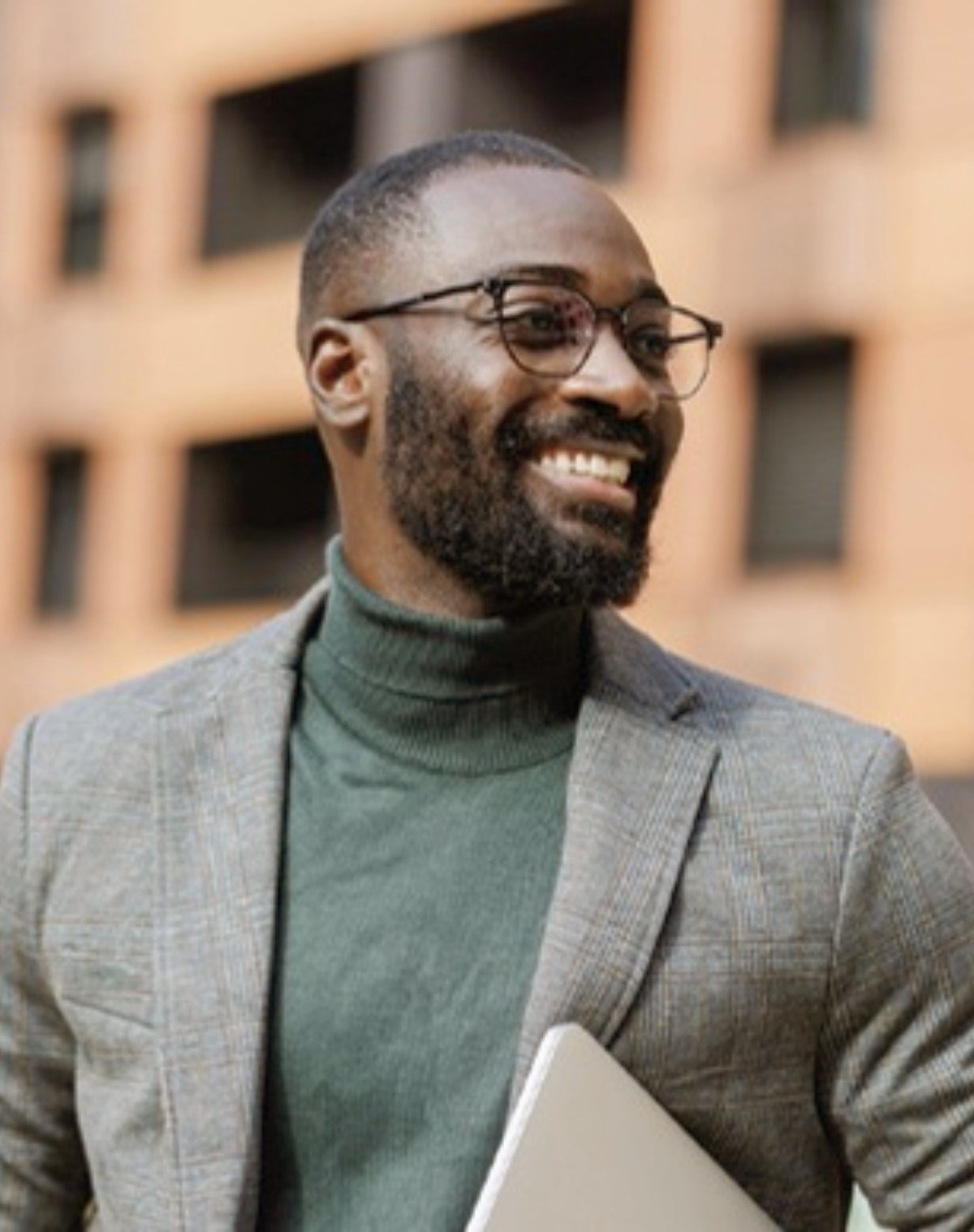 Smiling real estate professional with laptop