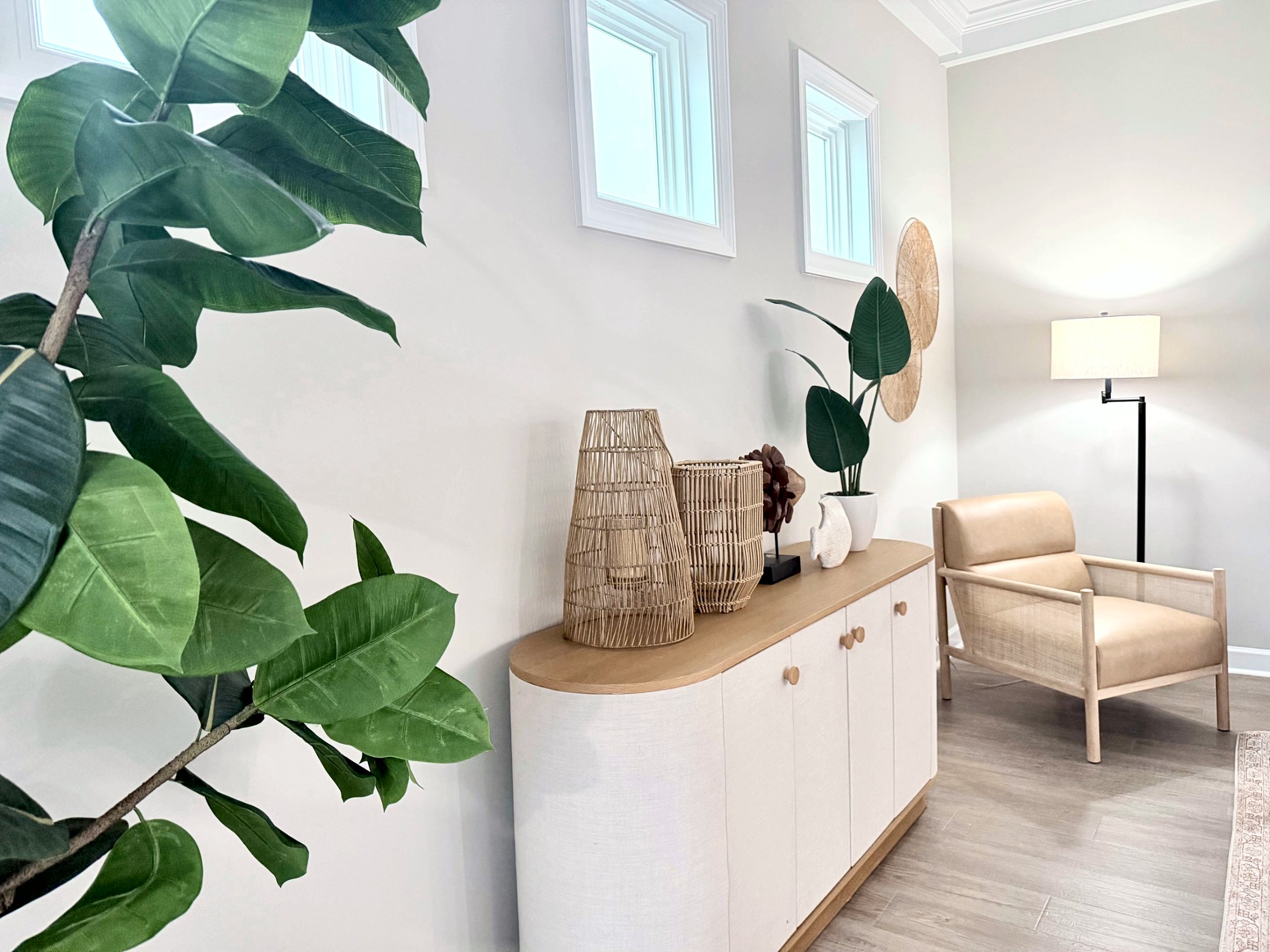 Staged entry with a linen console, woven accents, and a cozy reading chair